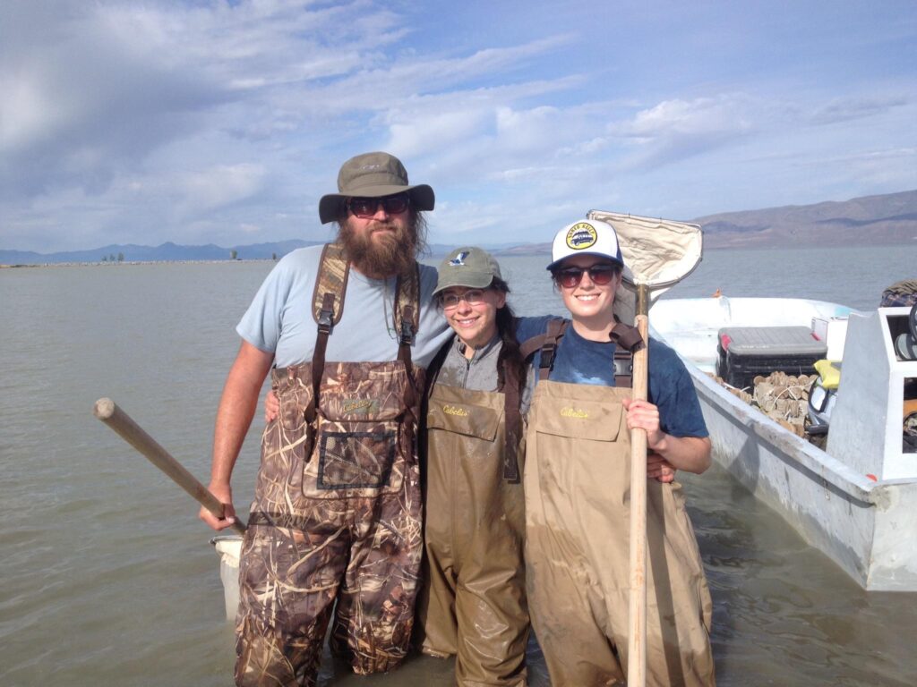 Ryan Dillingham stands with two other researchers on the shores of Utah Lake.