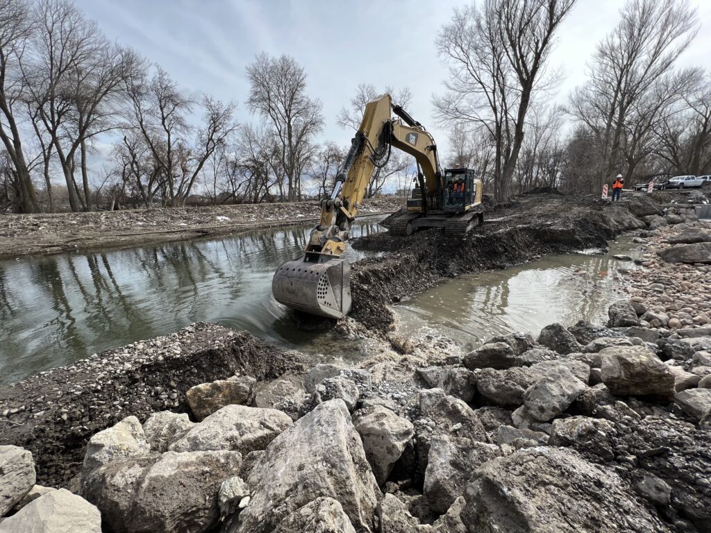 In three scoops, an excavator cut through the man-made levee and redirected the Provo River to a newly constructed floodplain and wetland marsh complex.